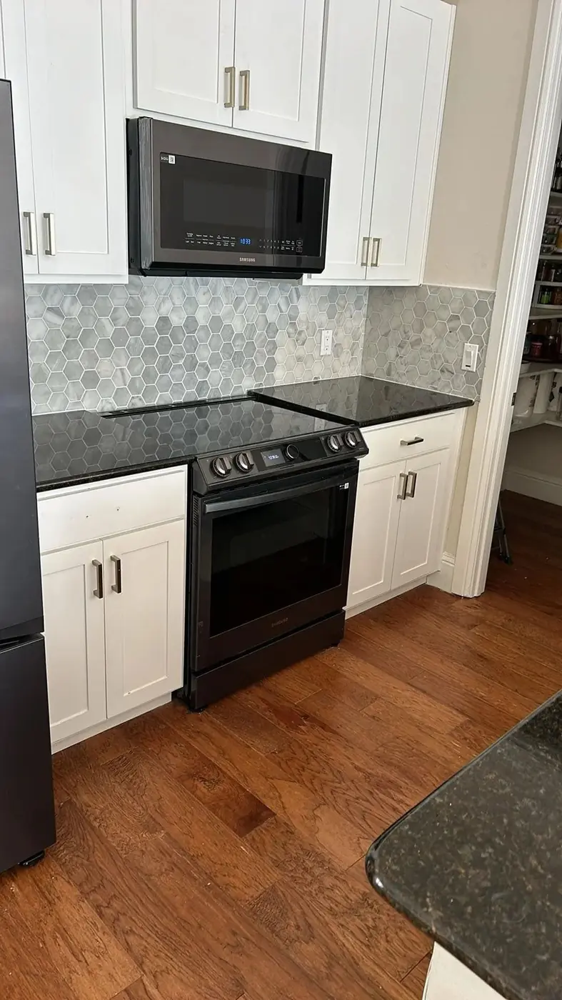 Remodelled kitchen with new cabinetry and counters by RGS General Contracting